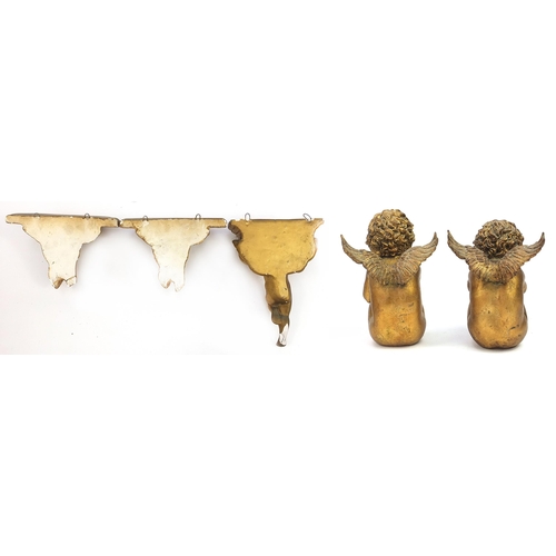 1382 - Three gilt Putti shelf brackets and pair of seated Putti figures, the largest 31cm high