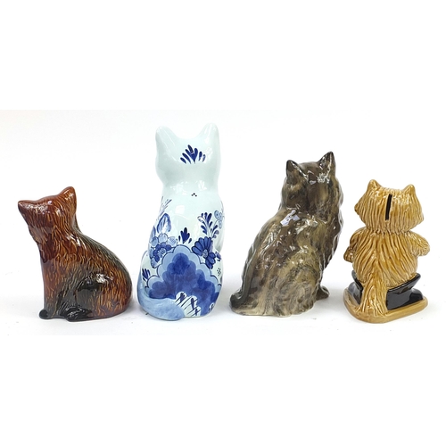 1201 - Four porcelain and pottery cats including Beswick, Delft and Wade moneybox, the largest 23cm high