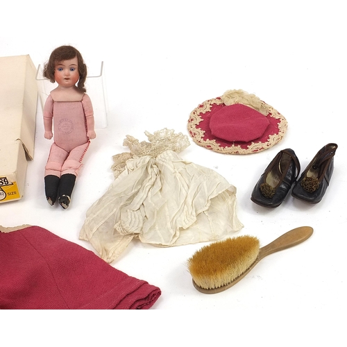 1478 - German bisque headed doll and a Victorian child's outfit with leather shoes, the doll 27cm high