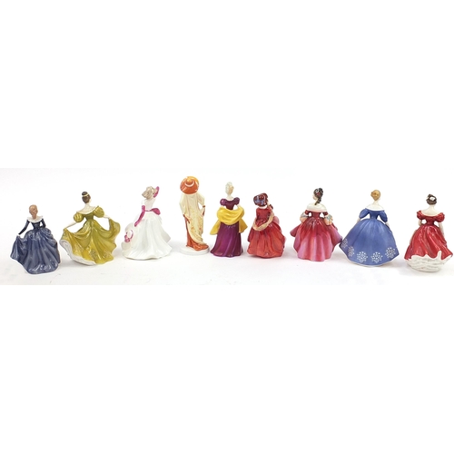 534 - Nine collectable figurines including Royal Doulton and Coalport, the largest 20cm high