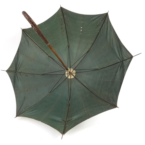 505 - Black forest parasol with carved bamboo design handle, 87cm in length