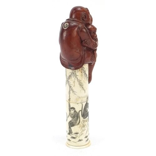 1271 - Japanese carved bone and boxwood scroll holder carved with two monkeys, 21.5cm high