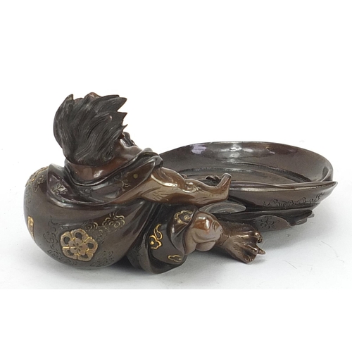 258 - Japanese mixed metal patinated bronze dish in the form of a devil pulling a sack, character marks to... 