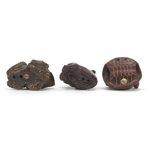 802 - Three Japanese carved wood netsukes comprising tiger, toad and rats on a tortoise, the largest 5cm i... 