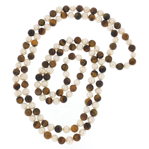 710 - Tiger's eye and cultured pearl necklace, 120cm in length