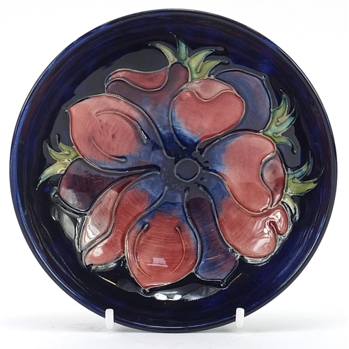 98 - Moorcroft Pottery shallow dish hand painted with a flower, 14.5cm in diameter