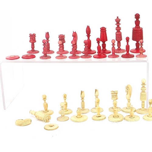 1476 - Collection of 19th century bone chess pieces, some stained, the largest pieces 8cm high