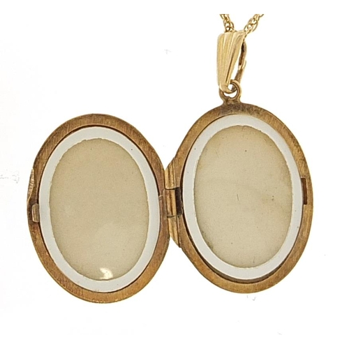 1864 - 9ct gold oval locket with engraved decoration on a 9ct gold rope twist necklace, 3.1cm high and 42cm... 