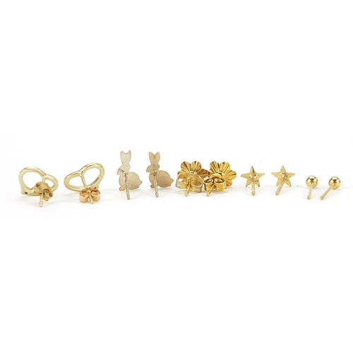 2131 - Five pairs of 9ct gold and yellow metal earrings including a 9ct gold flower head stud pair, the lar... 