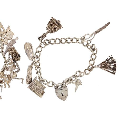 1788 - Two silver charm bracelets with a selection of mostly silver charms including koala, key and opening... 