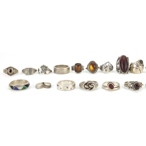 2165 - Thirty three silver and white metal rings, some set with semi precious stones, various sizes, 152.8g