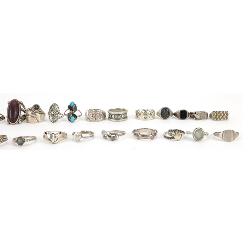 2165 - Thirty three silver and white metal rings, some set with semi precious stones, various sizes, 152.8g