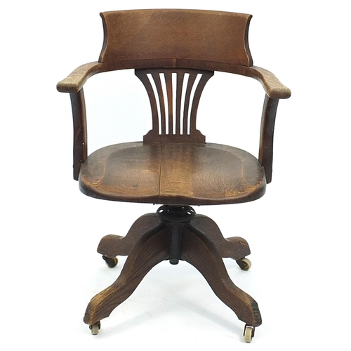 875 - Edwardian oak revolving captain's chair, 82cm high