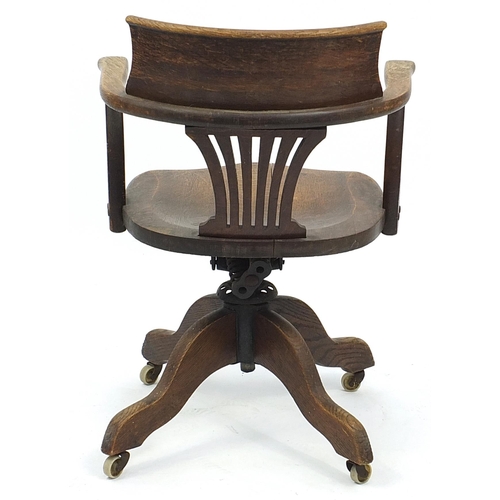 875 - Edwardian oak revolving captain's chair, 82cm high