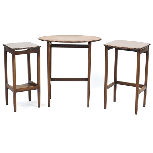 856 - Nest of three mahogany occasional tables with wavy edge, the largest 63cm H x 58cm W x 39.5cm D