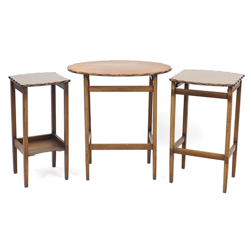 856 - Nest of three mahogany occasional tables with wavy edge, the largest 63cm H x 58cm W x 39.5cm D