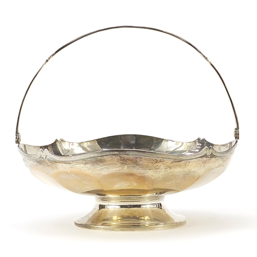 2208 - J W Benson Ltd, George V circular silver fruit bowl with swing handle, London 1935, 23.5cm in diamet... 