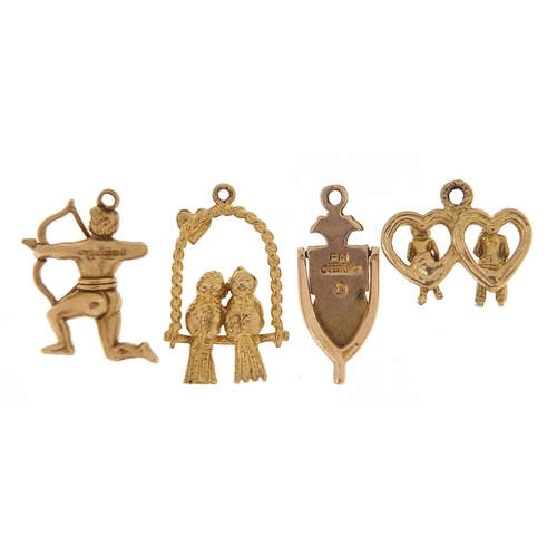 1711 - Four 9ct gold charms including lovebirds and an archer, the largest 2cm high, 6.7g