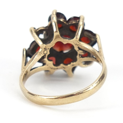 1881 - 9ct gold garnet flower head ring, size O, 4.6g