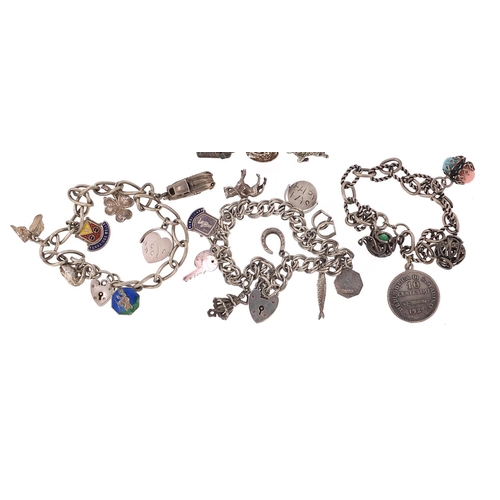 2199 - Three silver charm bracelets with a selection of mostly silver charms, 81.5g