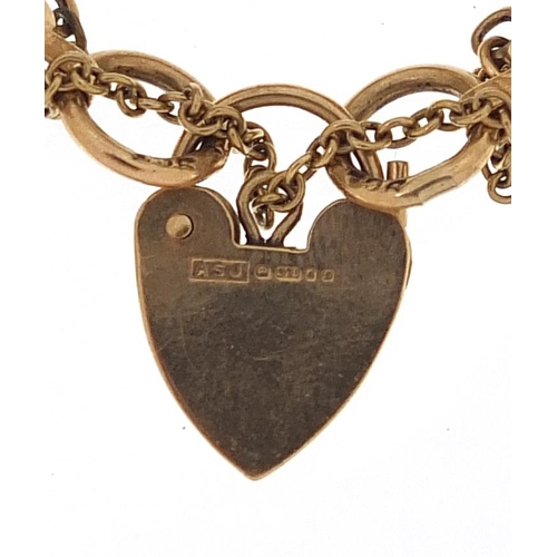 1659 - 9ct gold seven row gate link bracelet with love heart padlock 18.5cm in length, 23.9g