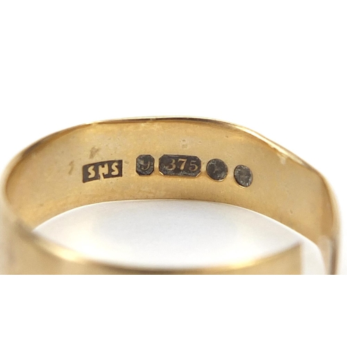 1768 - 9ct gold wedding band and 9ct gold buckle design ring set with a red stone, the largest size T, 4.8g