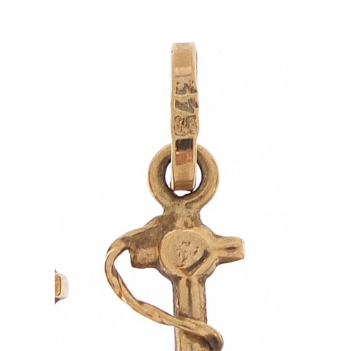 1802 - 18ct gold ladder charm, 9ct gold anchor charm and 9ct gold opening bible charm, the largest 2.1cm hi... 