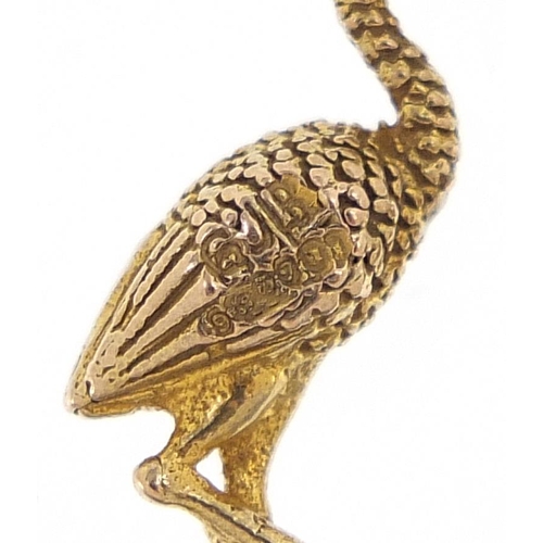 1991 - 9ct gold and enamel stork charm, 2.2cm high, 2.3g