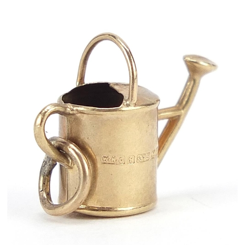 2067 - 9ct gold watering can charm, 1.6cm wide, 0.7g