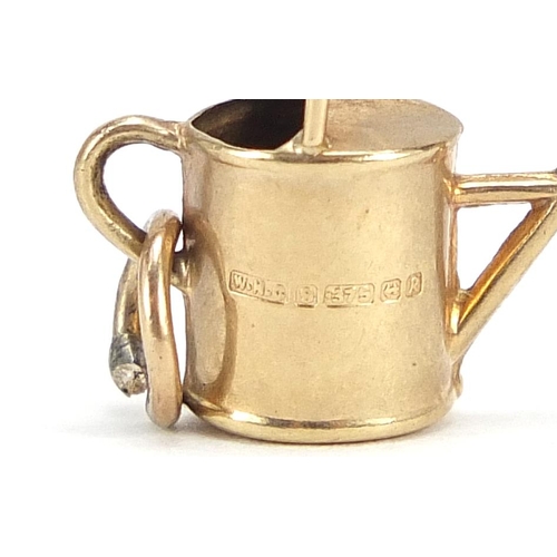 2067 - 9ct gold watering can charm, 1.6cm wide, 0.7g