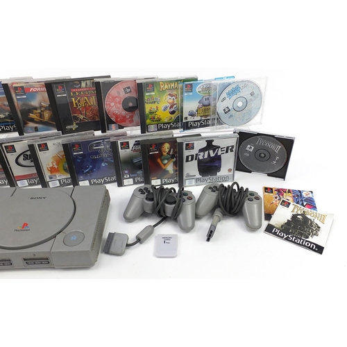 1517 - PlayStation 1 games console with controllers and a collection of games