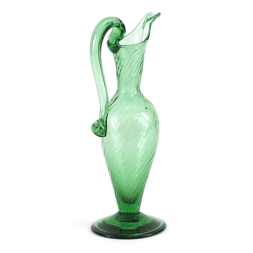 768 - Antique green glass ewer with writhen body, 20.5cm high