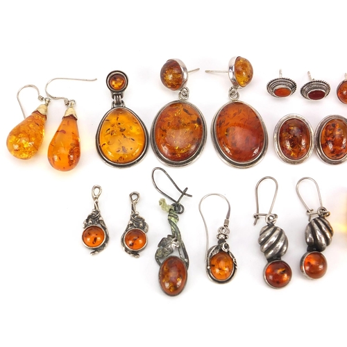 1963 - Collection of silver mounted natural amber earrings, the largest 4.5cm high, total weight 57.4g