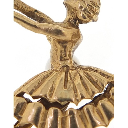 1720 - Two 9ct gold charms comprising fish with a pearl and ballerina with moving legs, the largest 2.7cm i... 