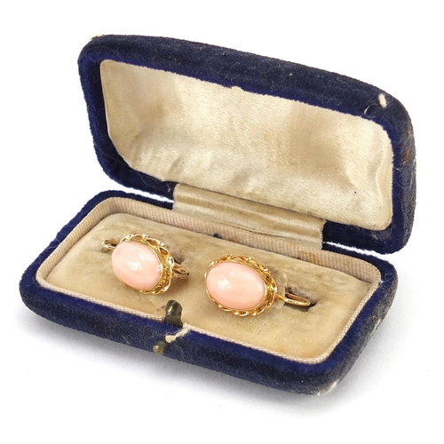 1766 - Pair of 18ct gold cabochon coral earrings housed in a fitted box, 2.3cm high, 5.8g