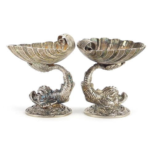 2219 - Pair of white metal dolphin design table salts, (tests as silver) 3.7cm high, 57.5g