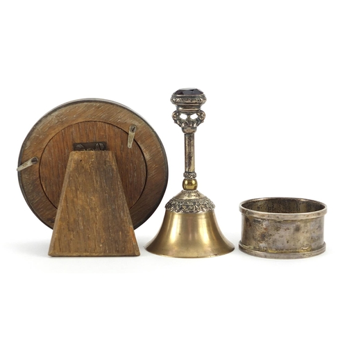 2281 - Silver objects comprising circular photo frame, napkin ring and brass bell with silver handle and pu... 