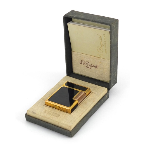 117 - S T Dupont gold plated and black enamel lighter with box and paperwork, numbered K3GS20