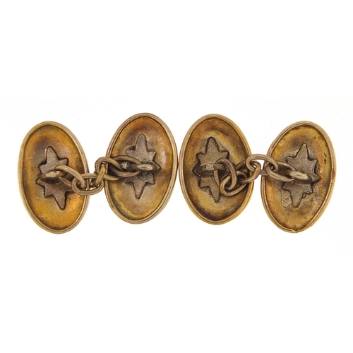 1961 - Pair of unmarked gold cufflinks engraved with flowers, (tests as 9ct gold) 1.5cm in length, 3.5g