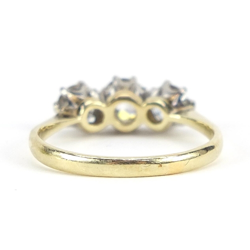 1655 - 18ct gold diamond three stone ring, the central diamond approximately 0.53 carat, the outer diamonds... 