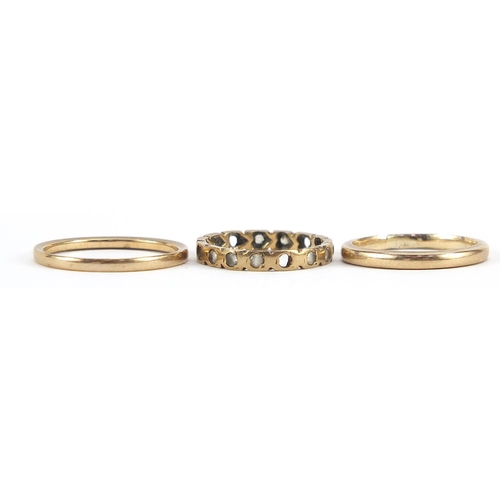 2011 - Two 9ct gold wedding bands and a 9ct gold clear stone eternity ring, sizes H, K and N, 4.2g