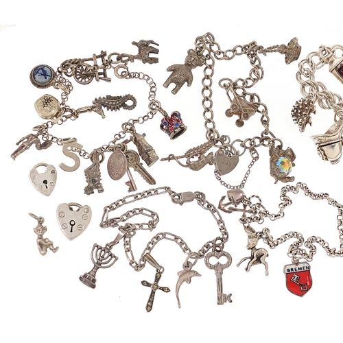 2064 - Seven silver charm bracelets with a selection of mostly silver charms, 123.8g