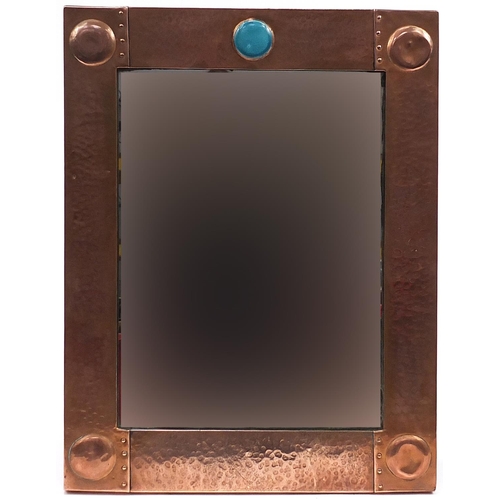 109 - Attributed to Liberty & Co, Arts & Crafts beaten copper wall mirror with inset Ruskin type cabochon,... 