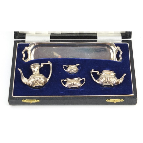 2290 - A Chick & Sons Ltd, Elizabeth II five piece silver doll's house tea and coffee service housed in a v... 