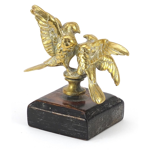 414 - Bronze car mascot in the form of two birds raised on a wooden plinth base, overall 10.5cm high