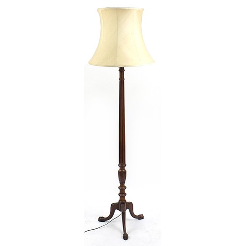 874 - Carved mahogany standard lamp with lion paw feet and beige silk lined shade, 183cm high