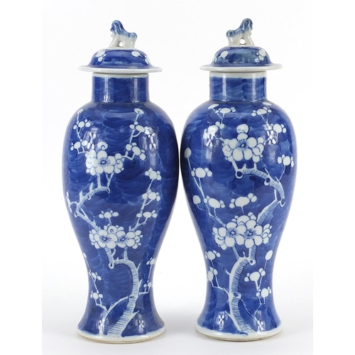 198 - Pair of Chinese blue and white porcelain baluster vases and covers hand painted with prunus flowers,... 