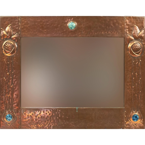 108 - Attributed to Liberty & Co, Arts & Crafts beaten copper wall mirror inset with three Ruskin type cab... 