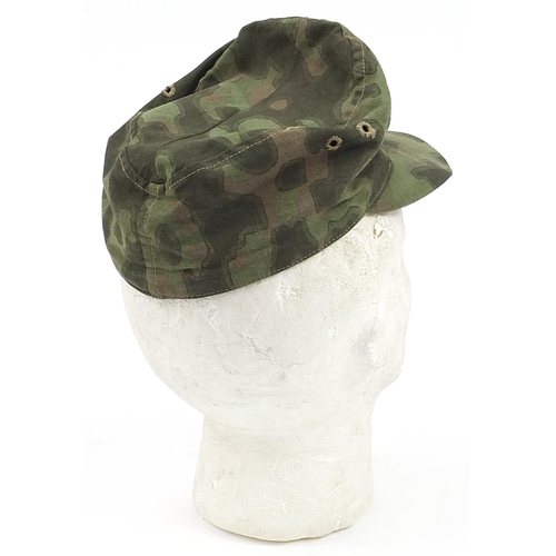 1568 - German military interest camouflage cap with badge