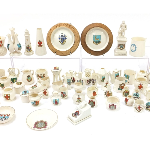 1362 - Collection of crested china, some Goss including shoes, lighthouses, cauldrons and cannon, the large... 